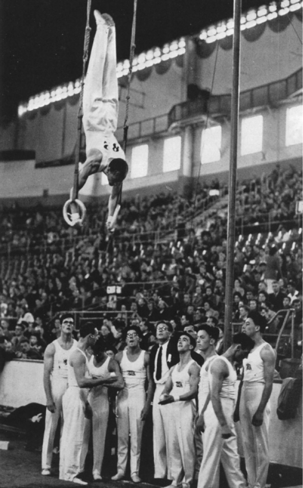 Alec Wales of the GB Men’s team on the rings watched by the rest of the British team 