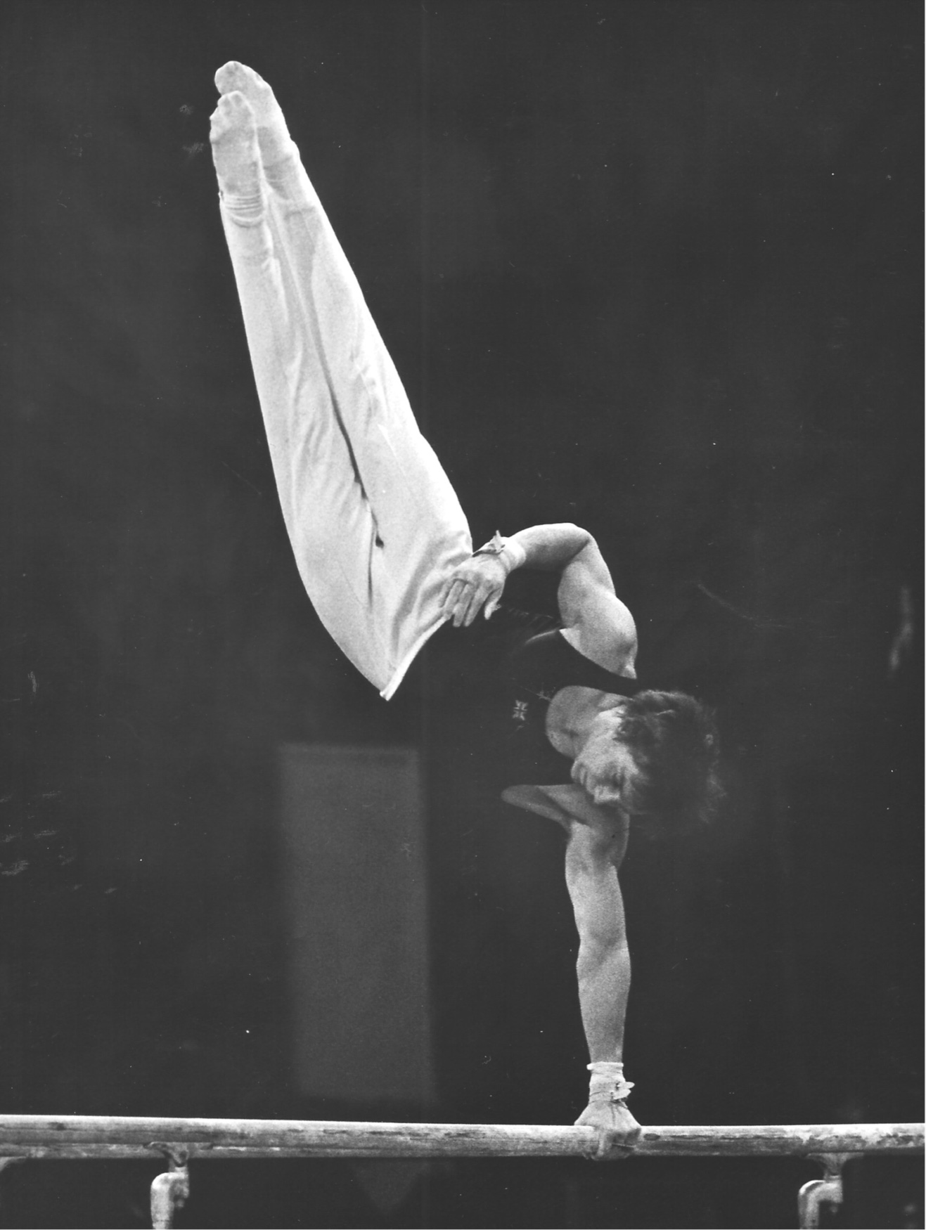 Keith Langley competing a Diamadov on Parallel Bars