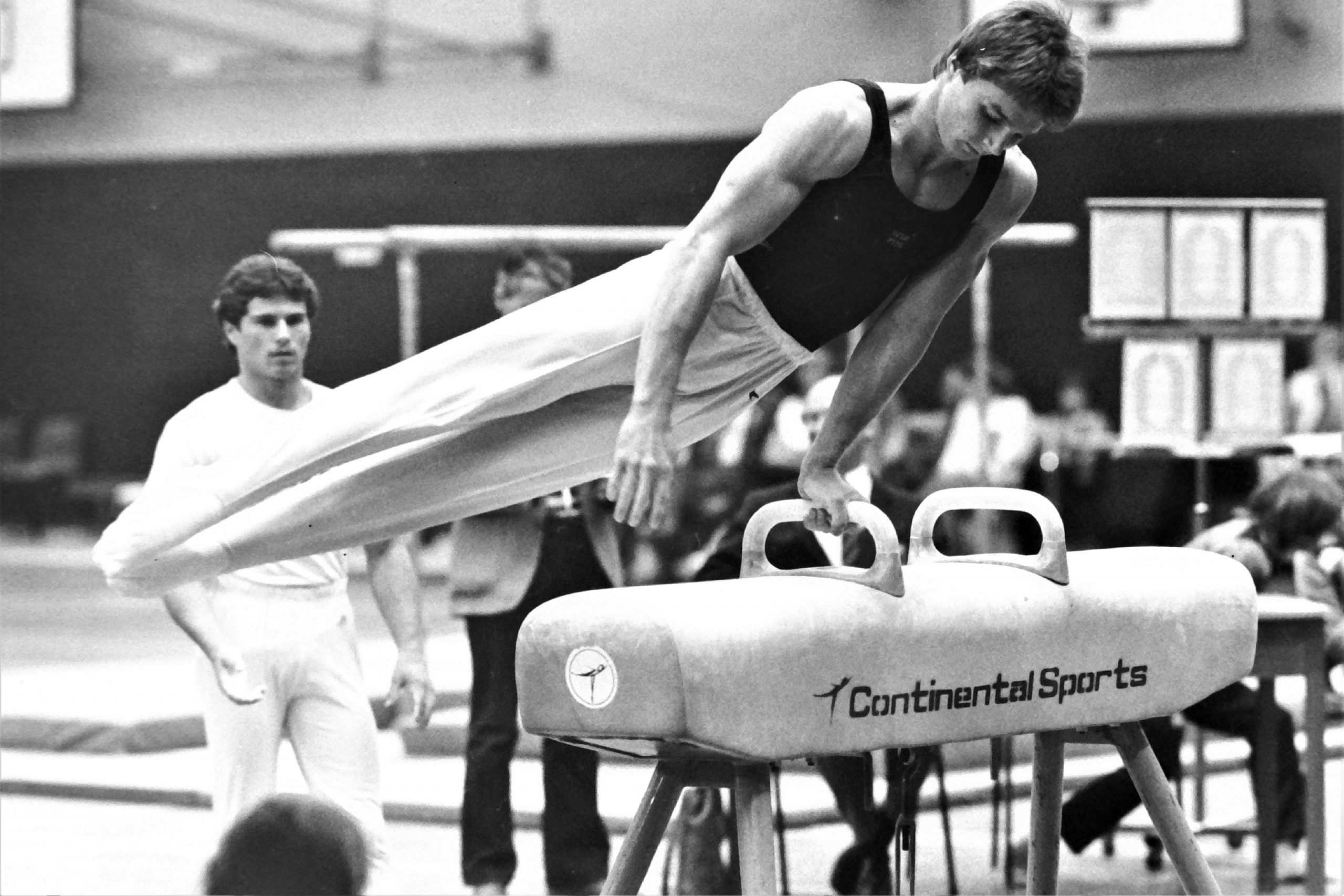Langley Keith warming up on Pommel Horse with Andrew Morris looking on