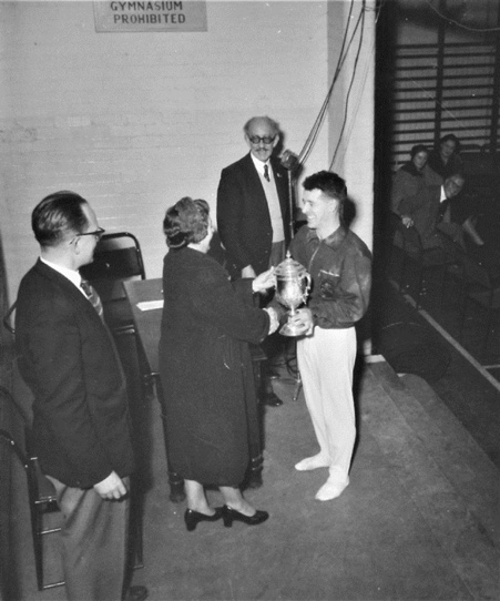 Nik did however win the Icelandic Cup awarded to the top scorer on floor exercise. Len Gross and Willy Loveday, London officials, look on