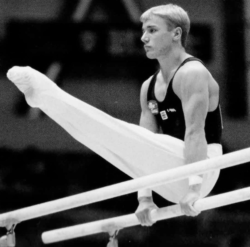 Kevin competing on P bars - photo Eileen Langsley/International Gymnast